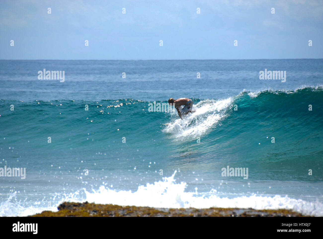 Surfer riding waves, Ponta Do Ouro, Mozambique Stock Photo