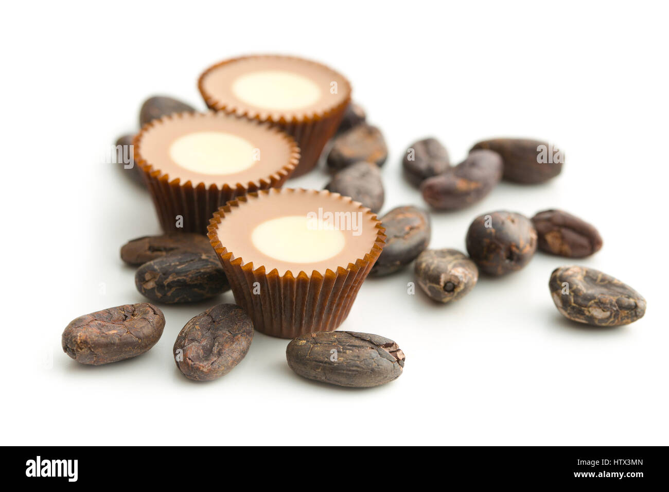 Sweet chocolate pralines with cocoa beans isolated on white background. Stock Photo