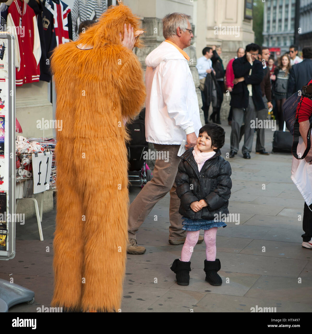 LONDON, ENGLAND April 12, 2016 Little girl smiles at a man dressed in