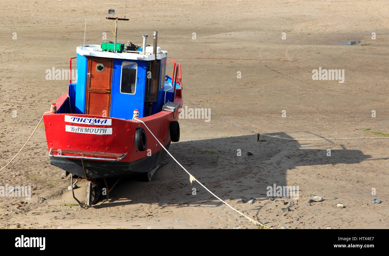 A colourful boat sits on Barmouth Sands, Barmouth, Wales, Europe Stock Photo