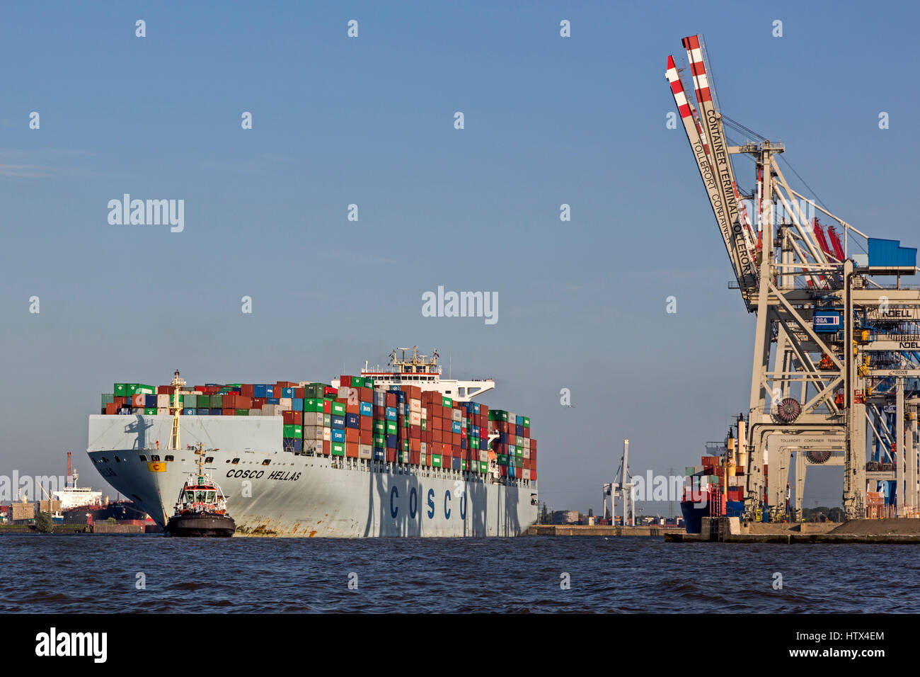 Container ship Cosco Hellas is pulled by tugboat, Port of Hamburg, Hamburg, Germany Stock Photo