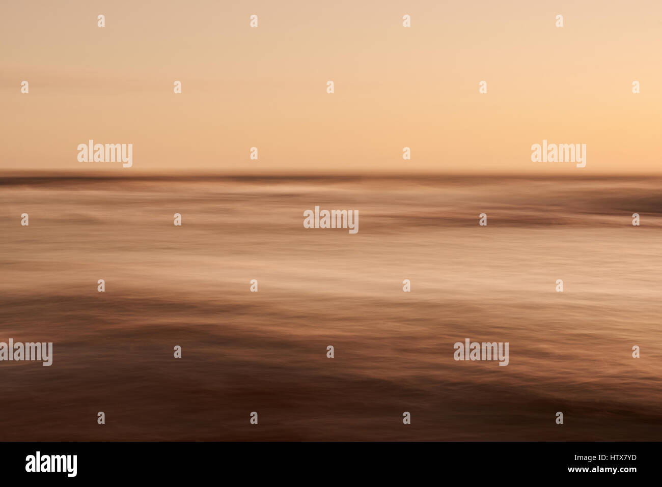 Smooth blurred sunset at sea background. Orange soft abstarct background wallpaper Stock Photo