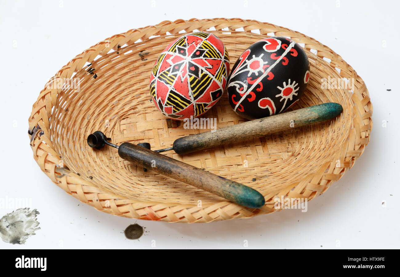The two ready pysankas are lying in the basket. There are also pisachokes inside. The Easter eggs are decorated using a wax-resist method. Stock Photo