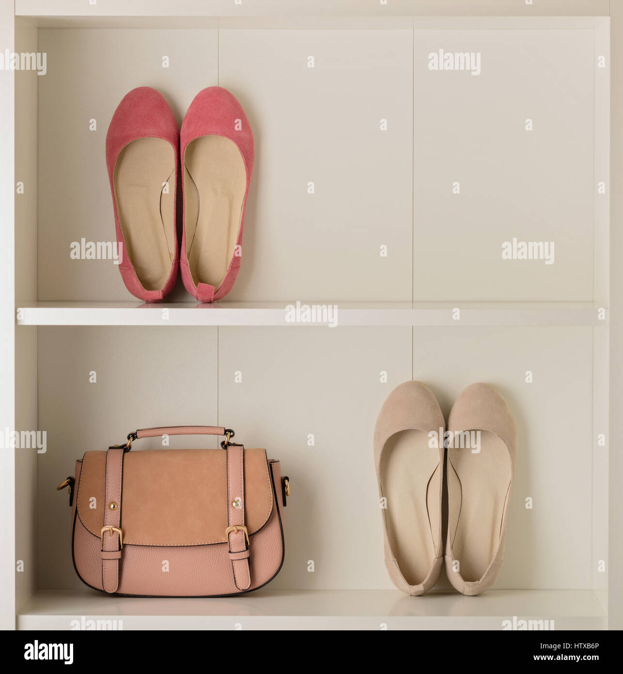Women's shoes (ballet shoes) and bag in the white wardrobe. Selective