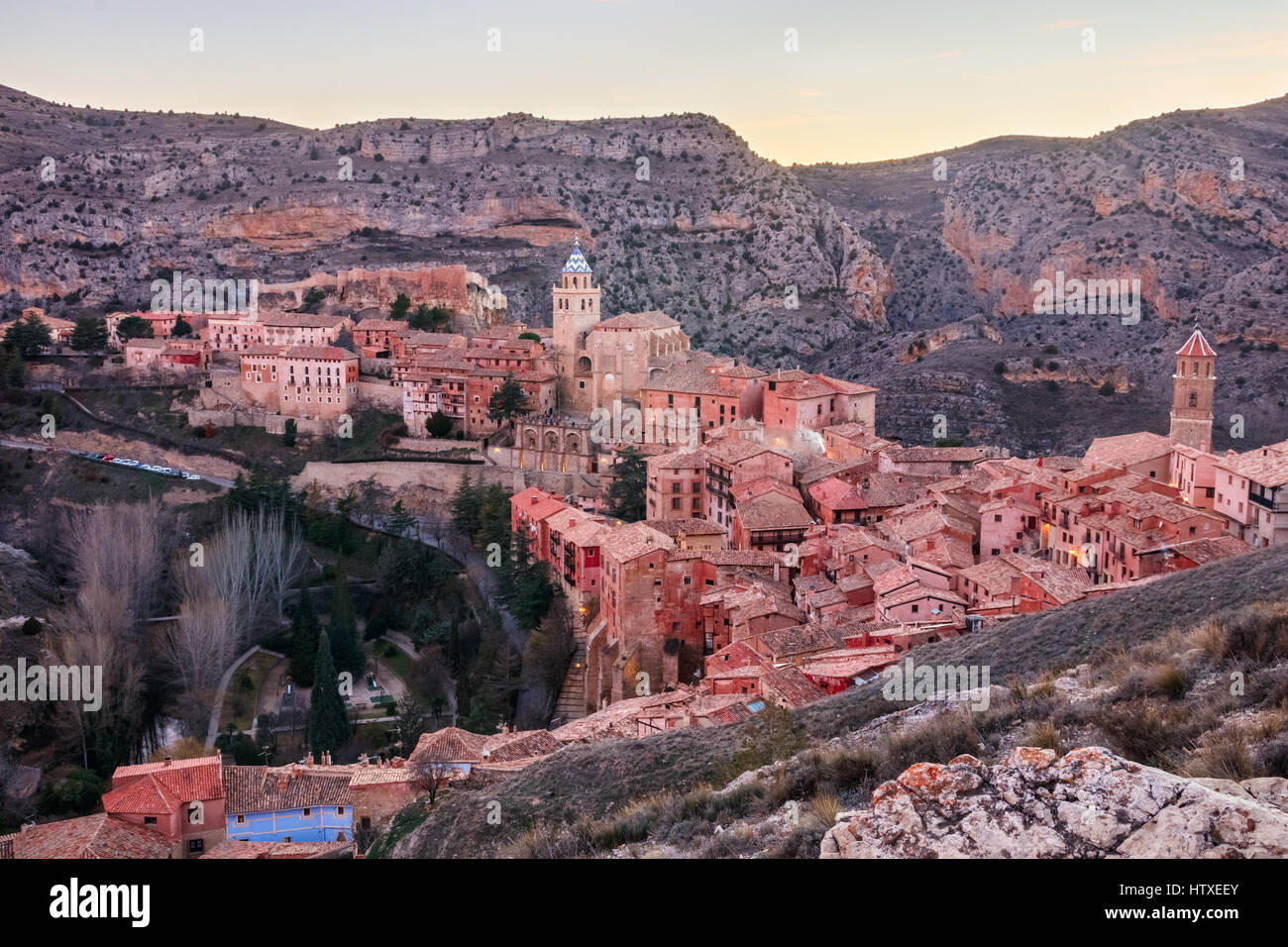 View of the medieval town Albarracin with the hills at the background and the afterglow of the sunset. Albarracin, Teruel, Spain. Stock Photo