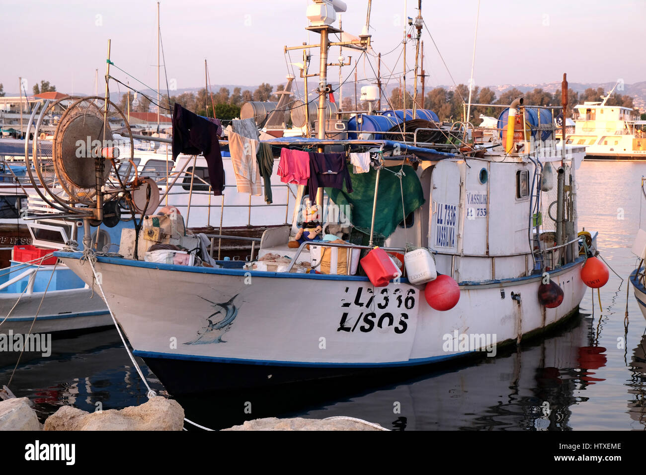 Colourful fishing boat in the harbour at Pafos, Cyprus. Paraphernalia on  the deck includes a figure of Popeye Stock Photo - Alamy