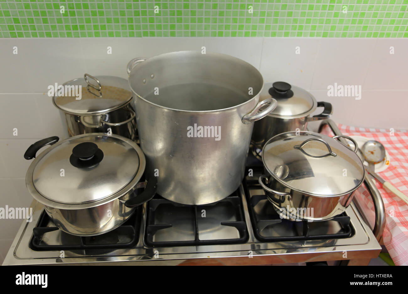 large and small pots in the industrial kitchen on the stove inside the  restaurant during the preparation of food Stock Photo - Alamy