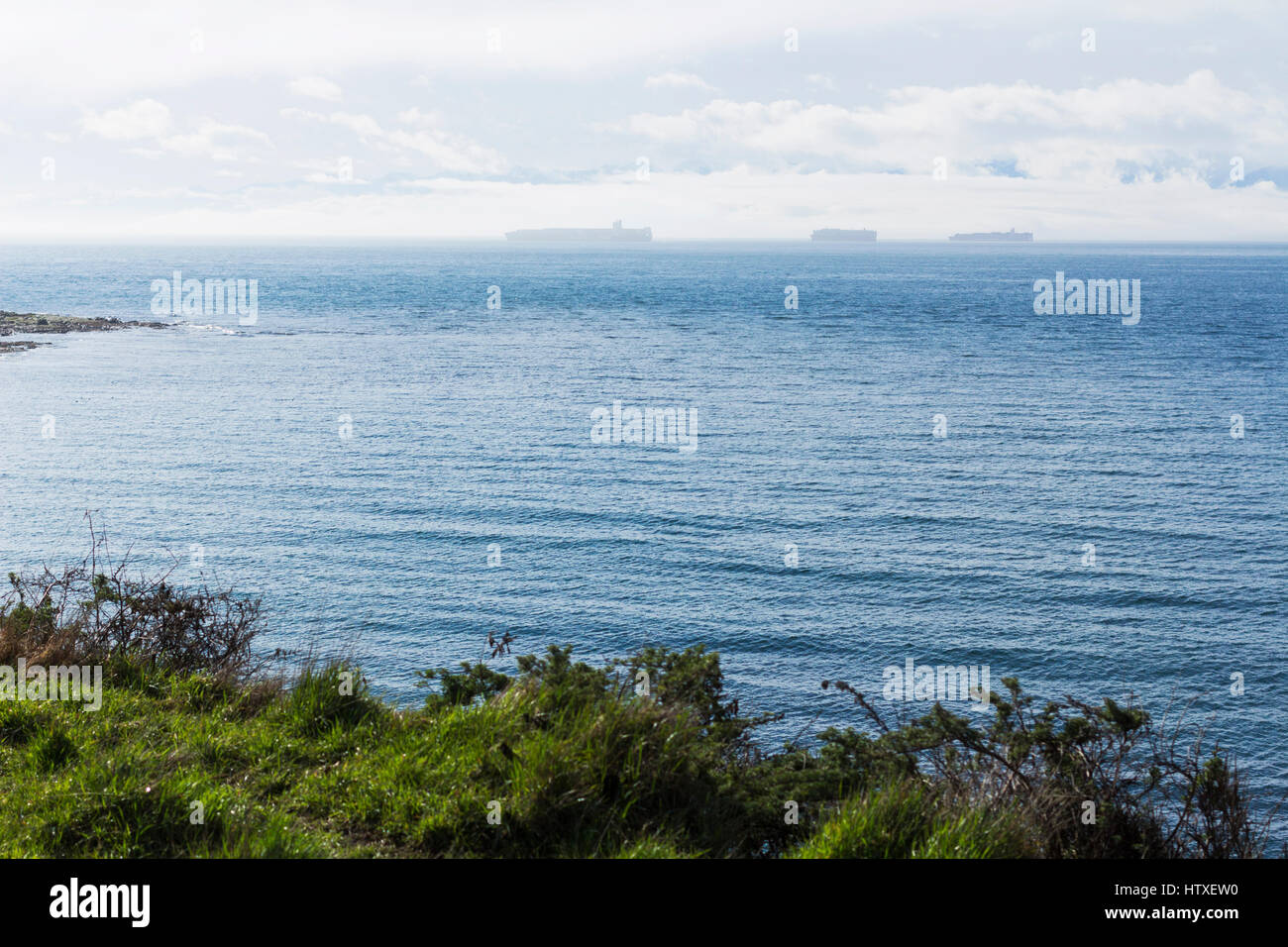 Freight vessels on Juan de Fuca Strait, from Dallas Road. Victoria, BC. Canada Stock Photo