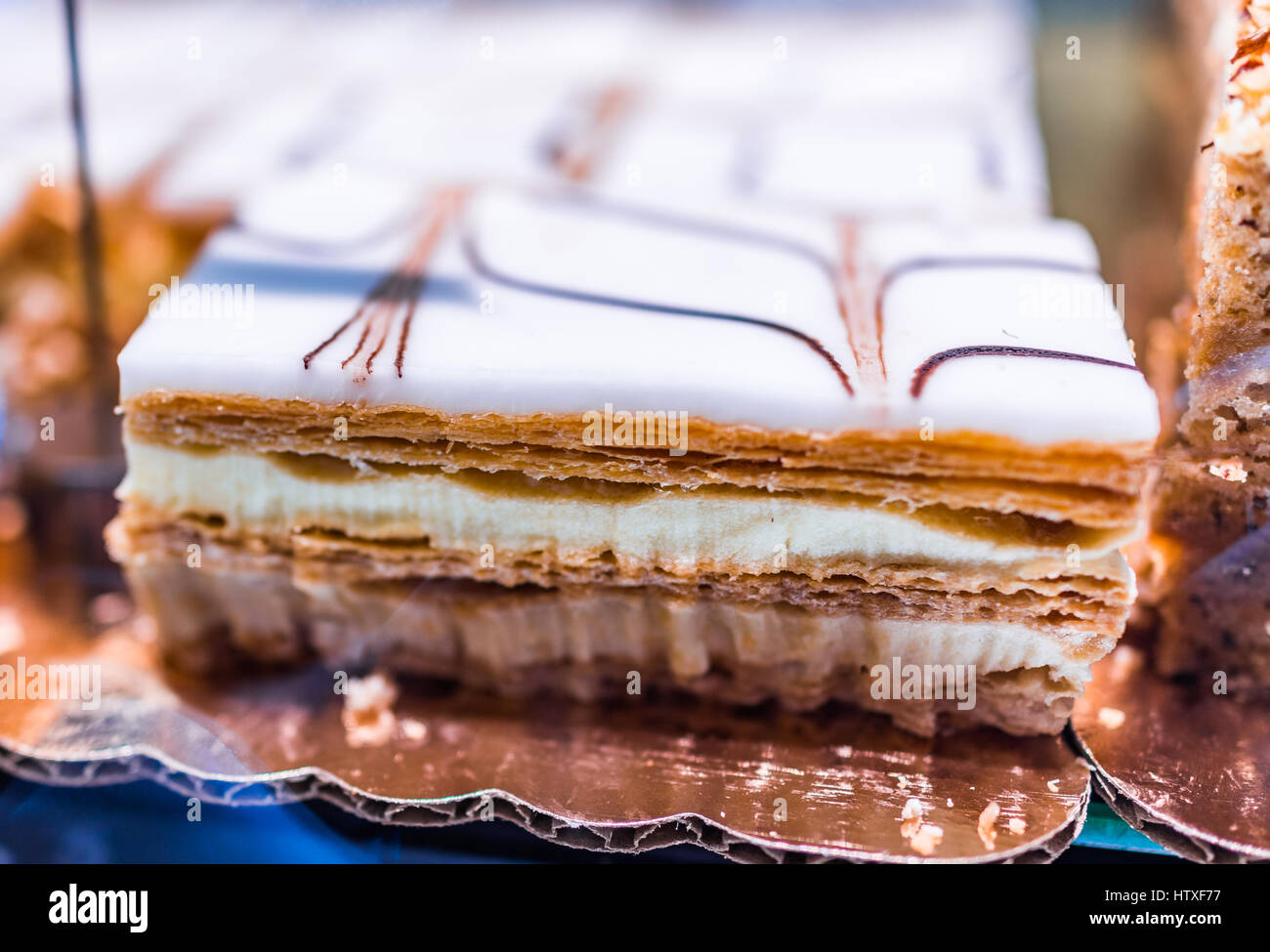 Puff pastry napoleon cake in bakery with whipped cream layers Stock