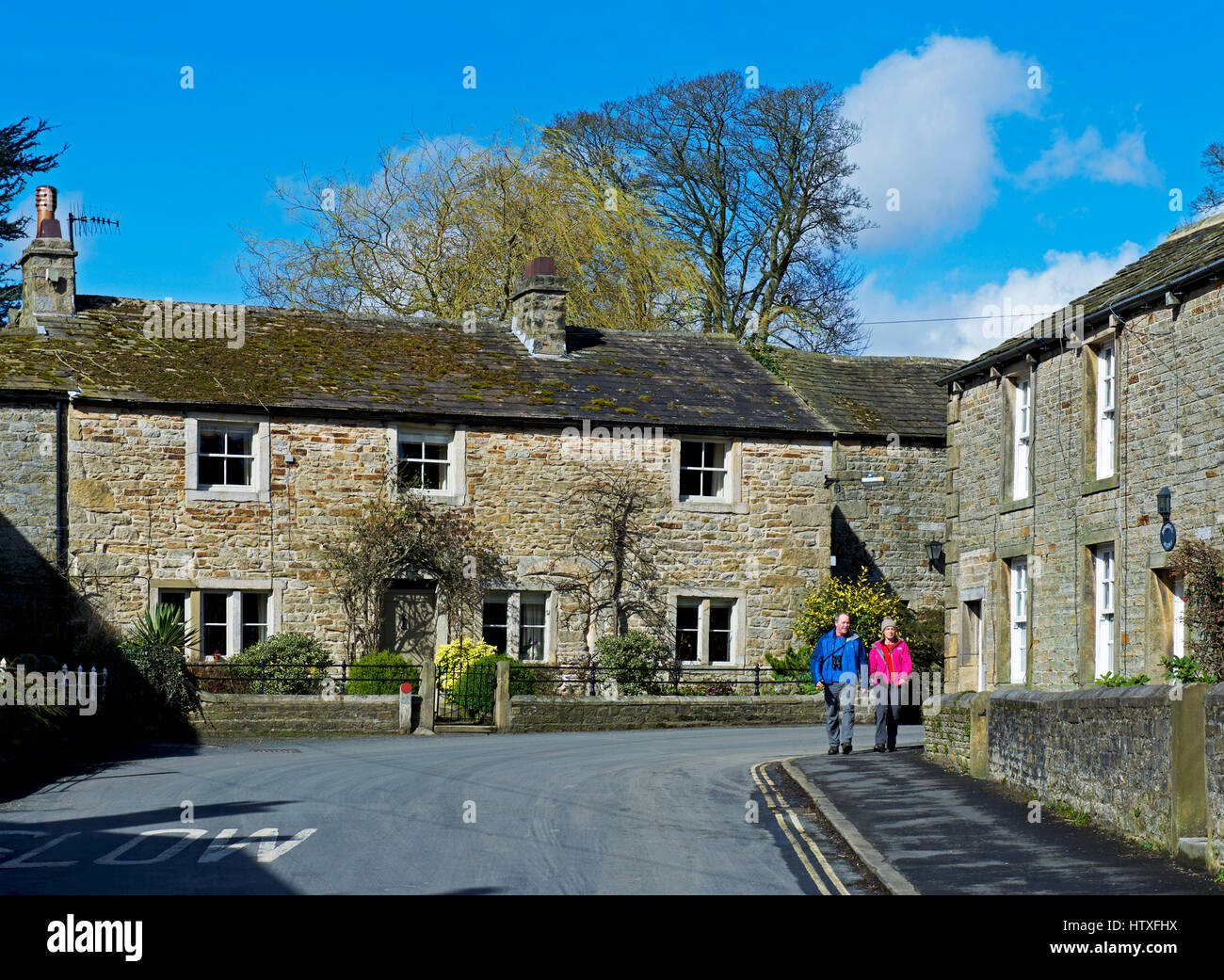 Couple walking in Burnsall, Wharfedale, Yorkshire Dales National Park, North Yorkshire, England UK Stock Photo