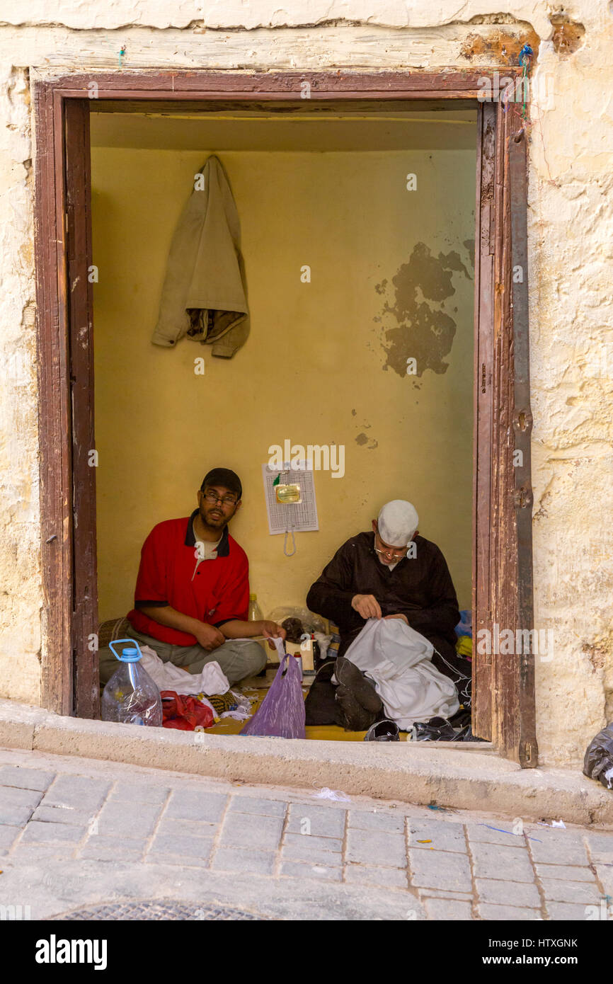 Fes, Morocco.  Two Tailors at Work inside their Shop in the Medina. Stock Photo