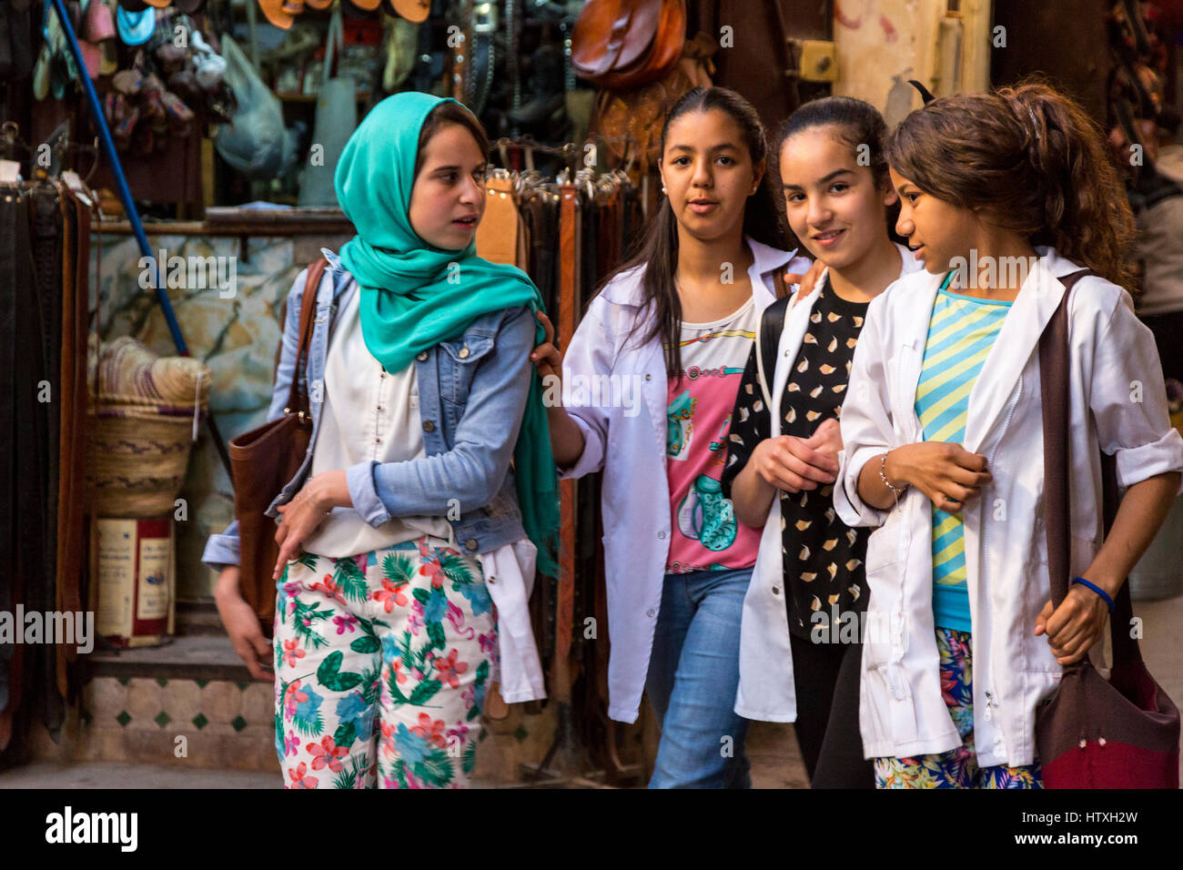 Fes, Morocco.  Young Women in Modern Moroccan Dress Styles Walking in the Old City. Stock Photo