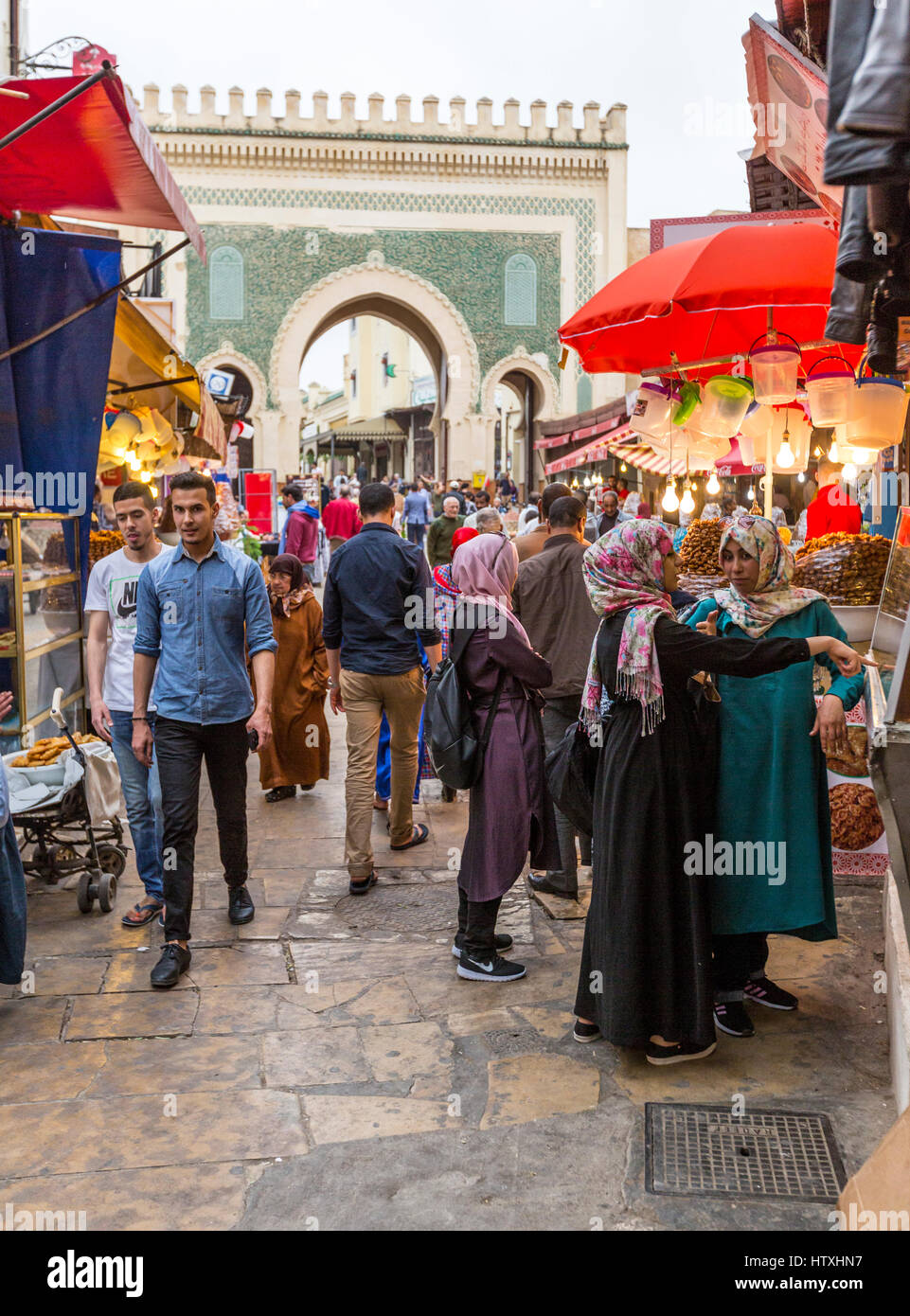 Fes, Morocco.  Moroccans in the Medina, by the Bab Bou Jeloud. Stock Photo