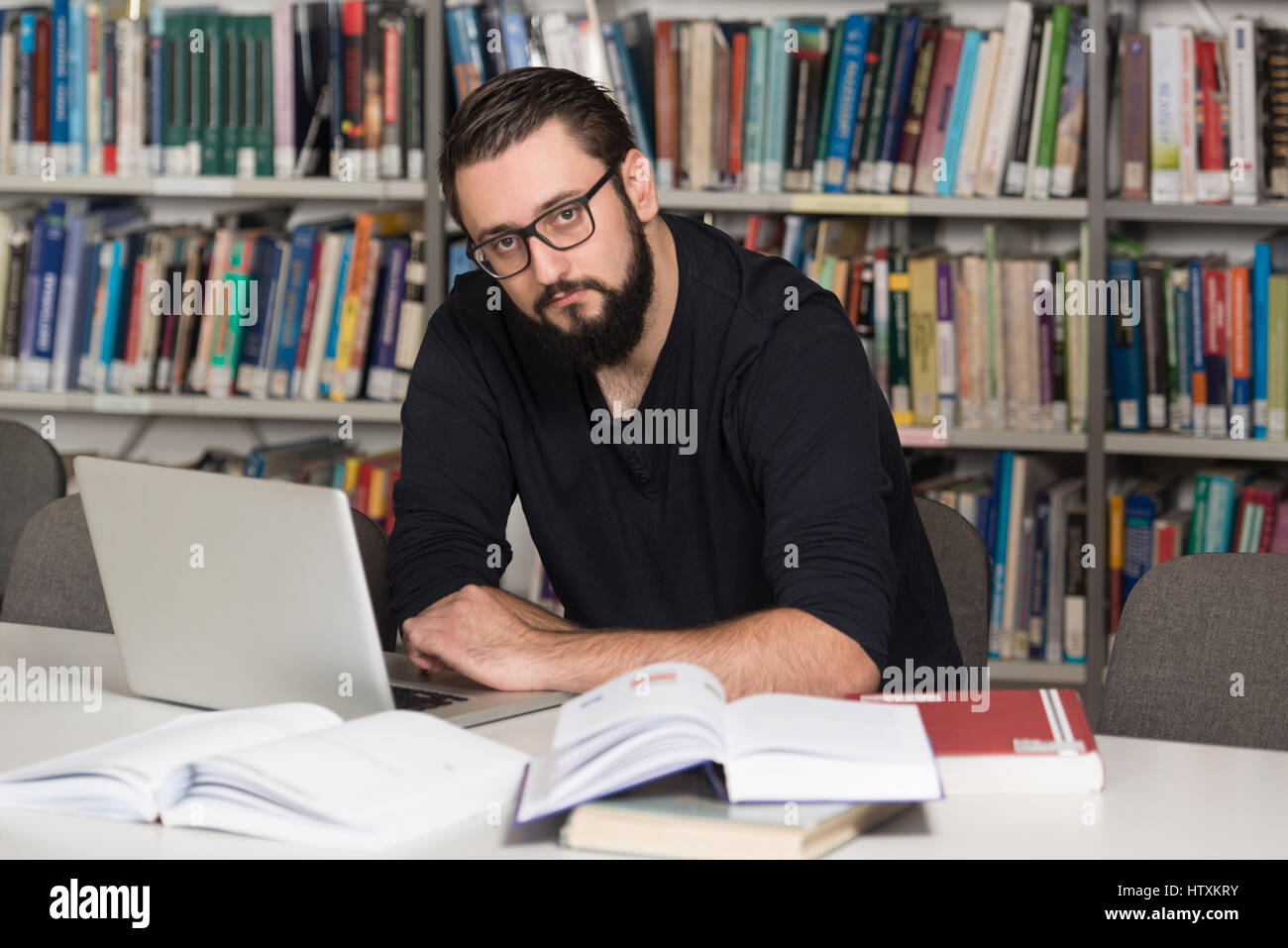 Guy In Library In The Library - Handsome Male Student With Laptop And Books Working In ...