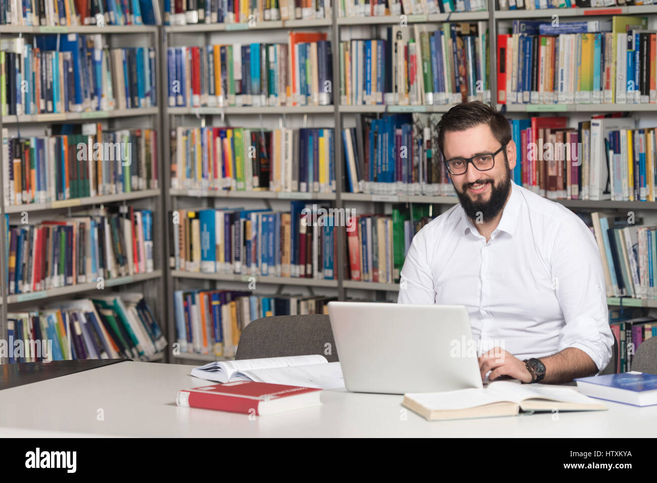 Guy In Library In The Library - Handsome Male Student With Laptop And Books Working In ...