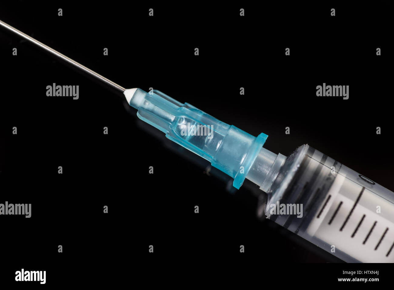 Empty disposable syringe. Closeup of the tip and needle isolated on ...