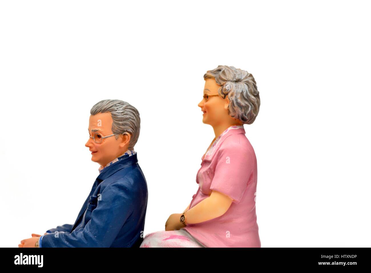 Miniature figurine pensioner couple facing left. Stock Photo