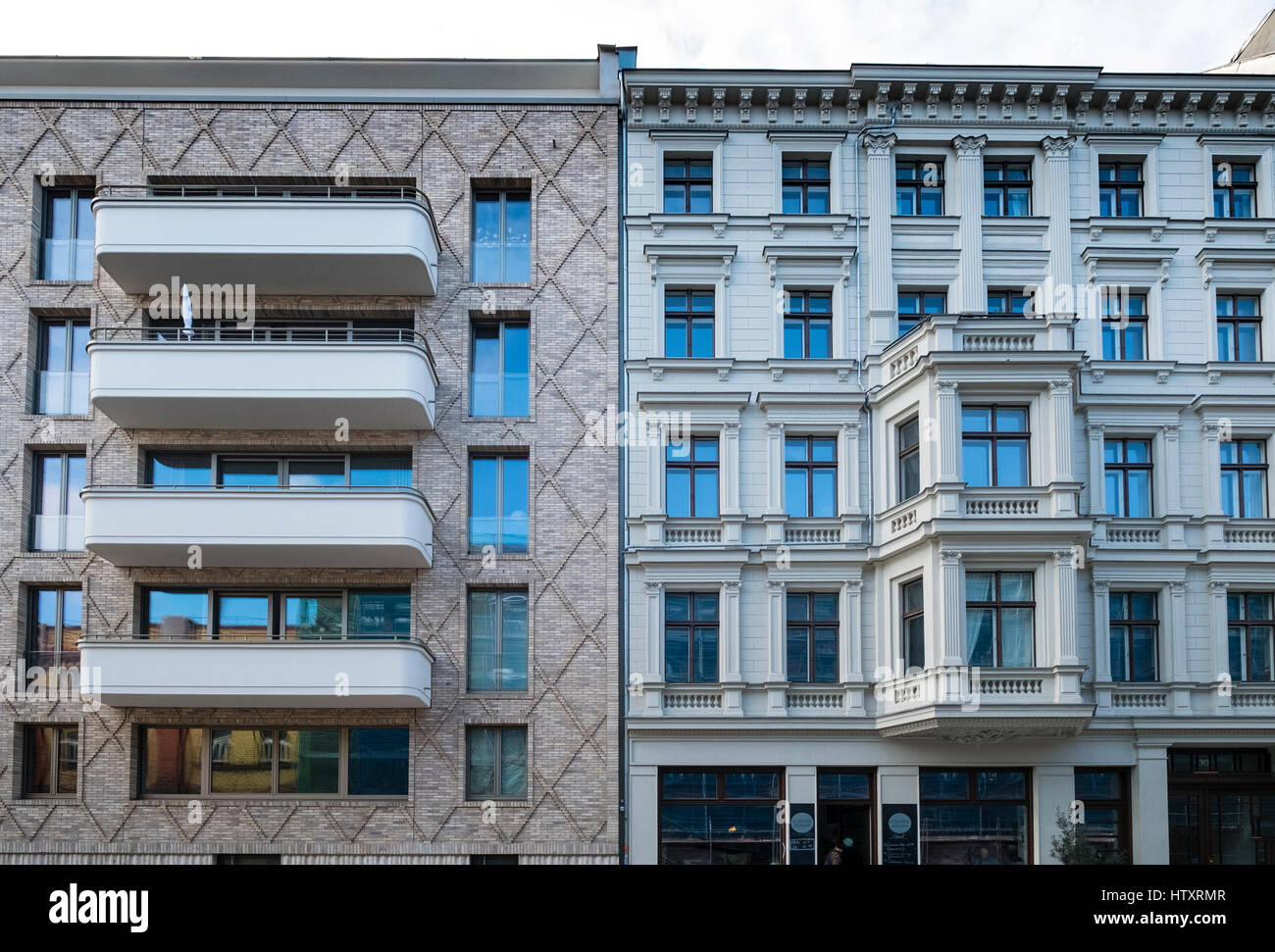 Contrast between modern apartment building and traditional building in gentrified district of Prenzlauer Berg, Berlin, Germany Stock Photo