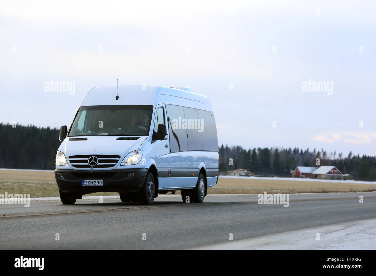 JOKIOINEN, FINLAND - DECEMBER 3, 2016: White Mercedes-Benz Sprinter minibus at speed on the road in winter. Stock Photo