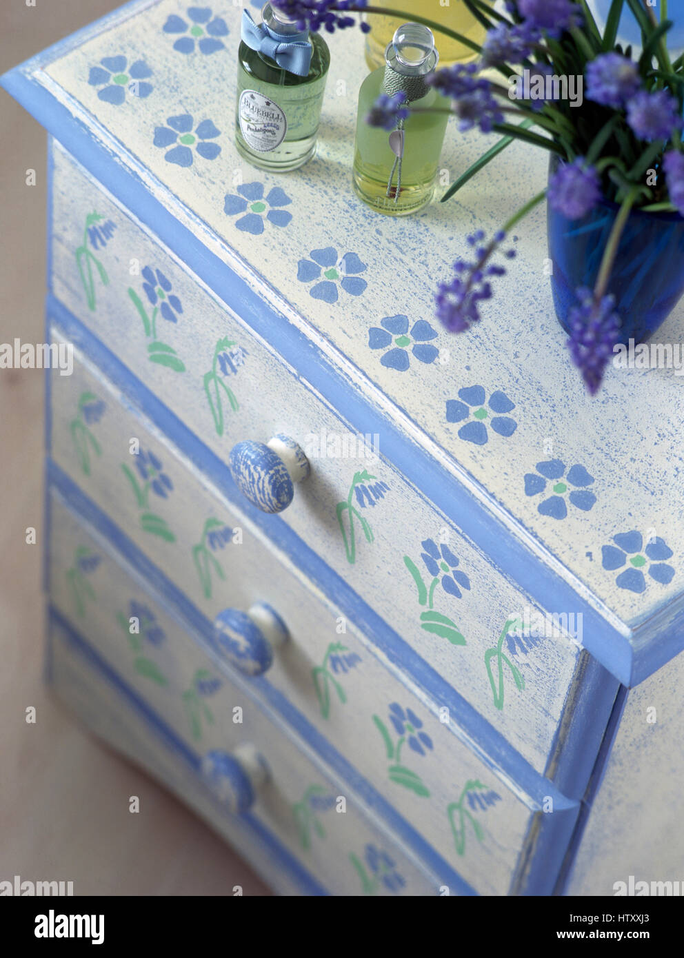 Close Up Of A Painted Chest Of Drawers With A Stenciled Floral