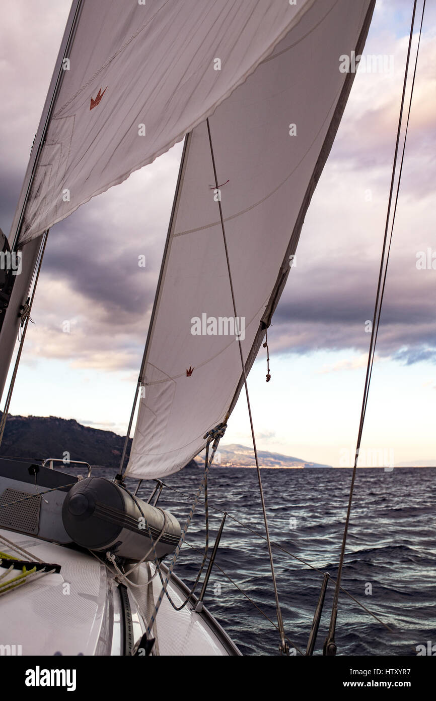 Yacht, Jib sail, rigging and sunset over the Mediterranean sea. View