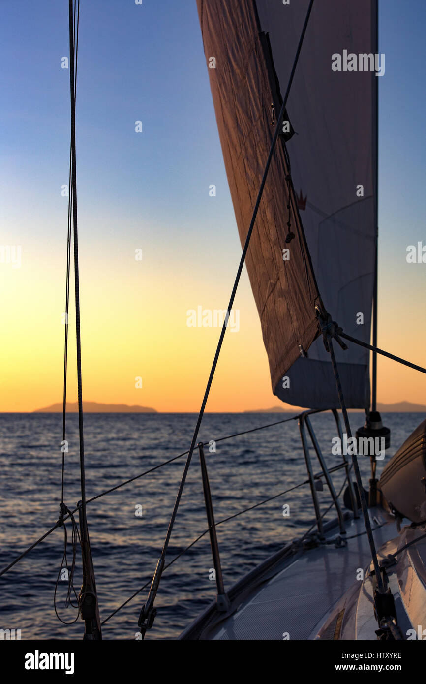 Yacht, Jib sail, rigging and sunset over the Mediterranean sea. View