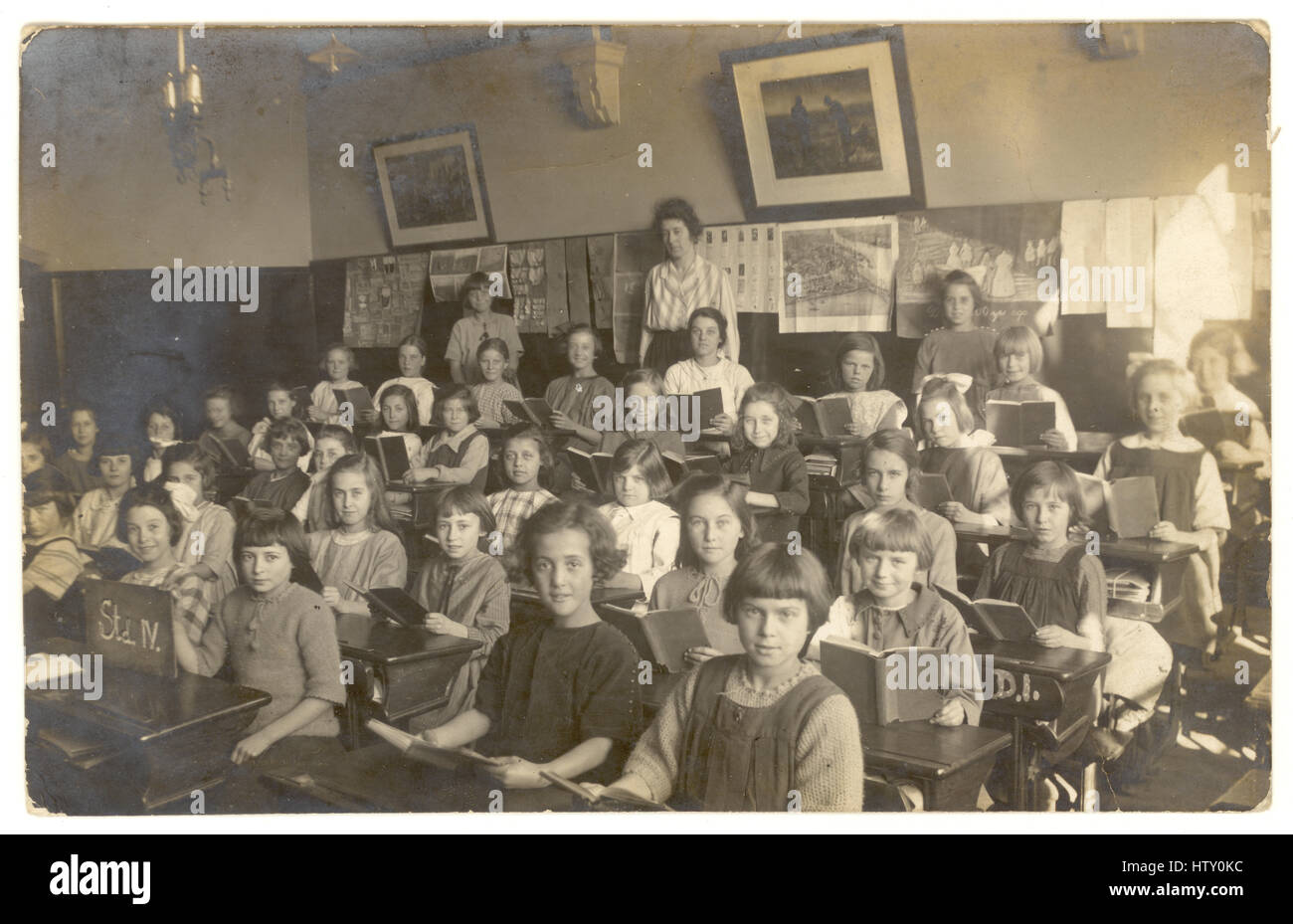 Early 1900's postcard of young school girls in classroom,U.K. circa 1920's Stock Photo