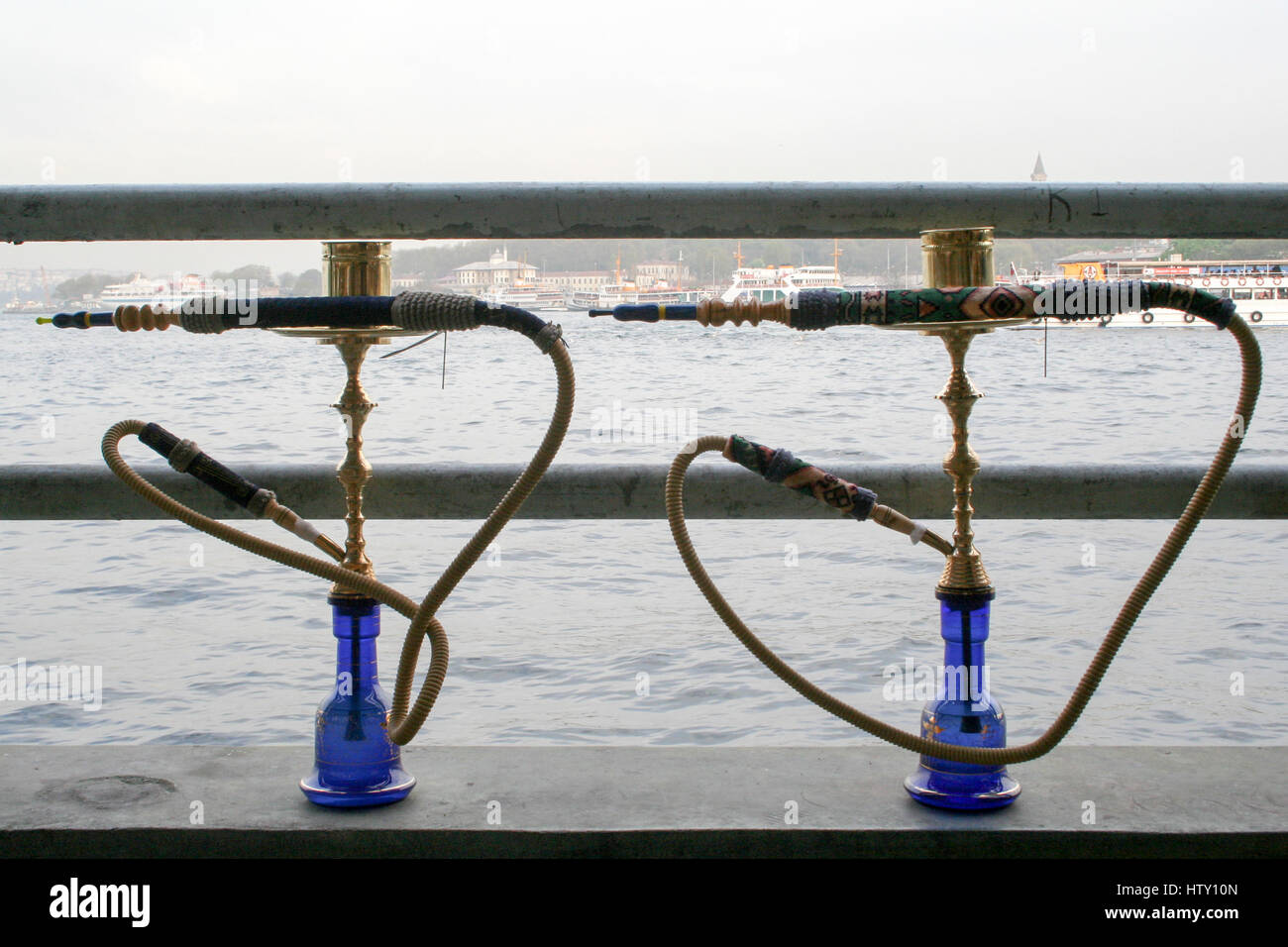 two middle eastern water pipes with the Bosphorus straits, Istanbul in