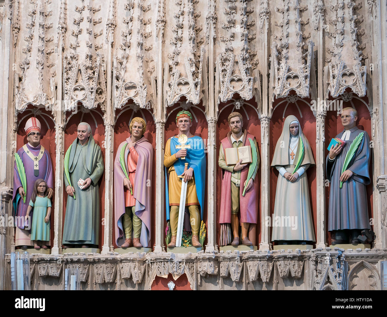 Seven restored Martyr statues in nave of St Albans Abbey church Hertfordshire England UK Stock Photo