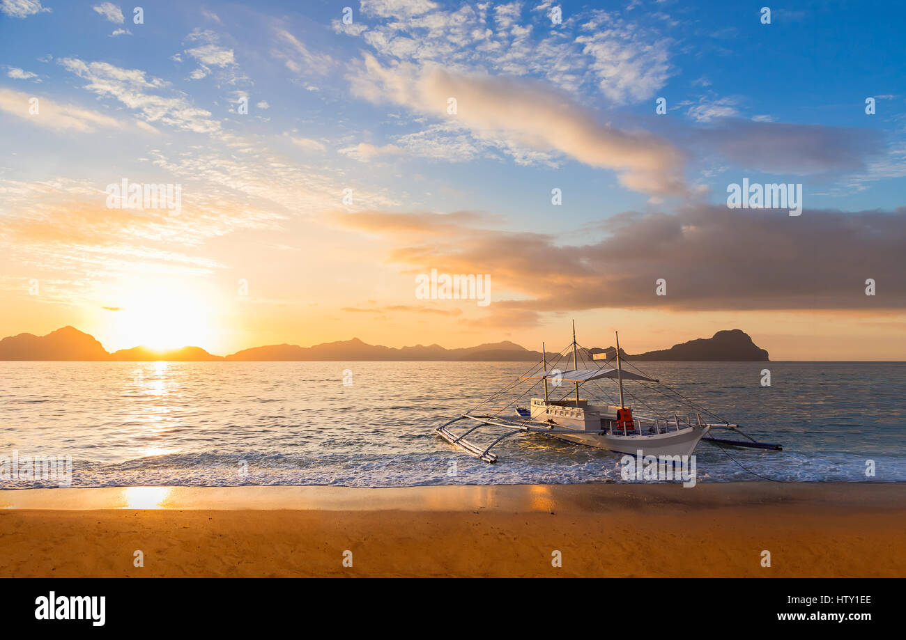 Traditional banca boat at sunset on IpilIpil beach near El Nido