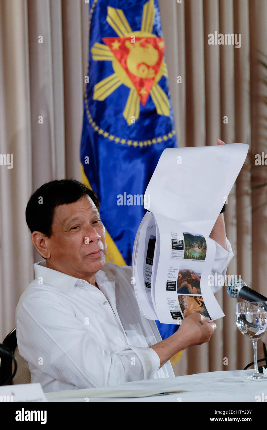 Philippine President Rodrigo Duterte holds up a report on environmental damages caused by illegal mining during a press conference at the Rizal Hall at the Malacanang Palace March 13, 2017 in Manila, Philippines. Stock Photo