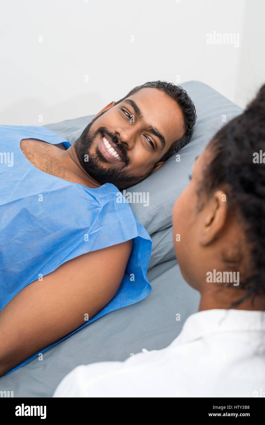 Smiling Young Patient Looking At Radiologist During X-ray Scan Stock ...