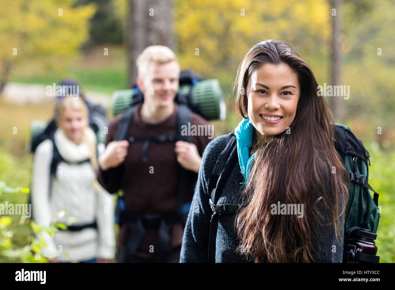 Portrait Of Beautiful Young Woman Hiking In Forest Stock Photo