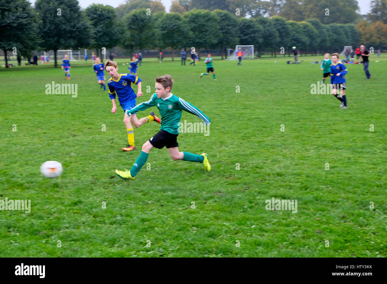 Boys playing football (soccer) in a park on Saturday morning Great