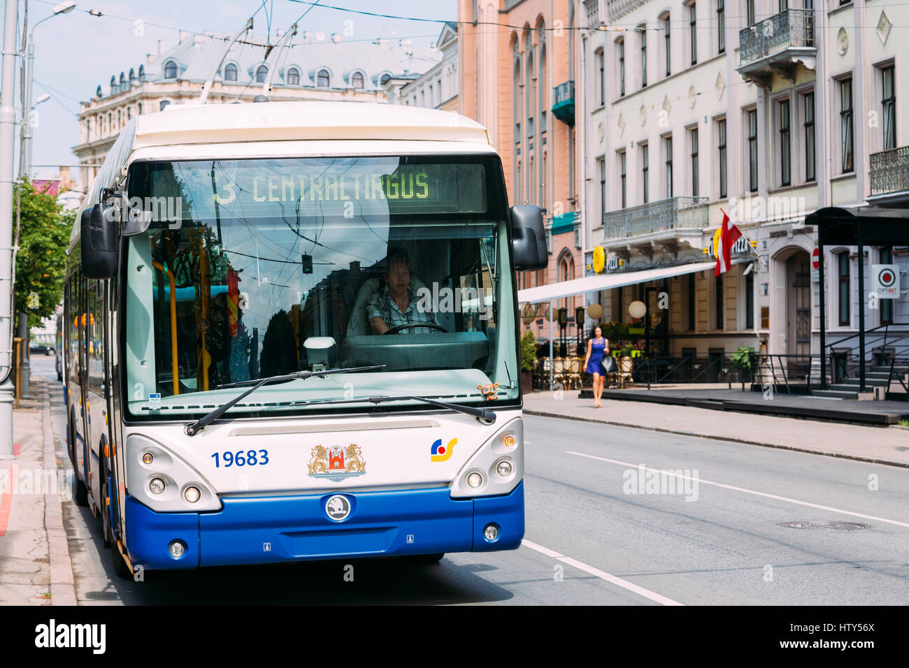 Riga, Latvia - July 1, 2016: Public trolleybus driven by a female driver on summer street in Riga, Latvia Stock Photo