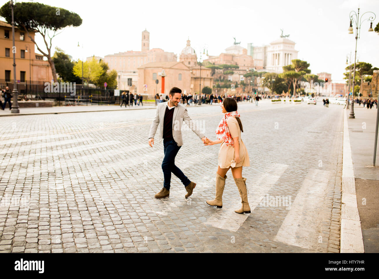 Casual young couple holding hands walking in Rome, Italy, Europe. Stock Photo