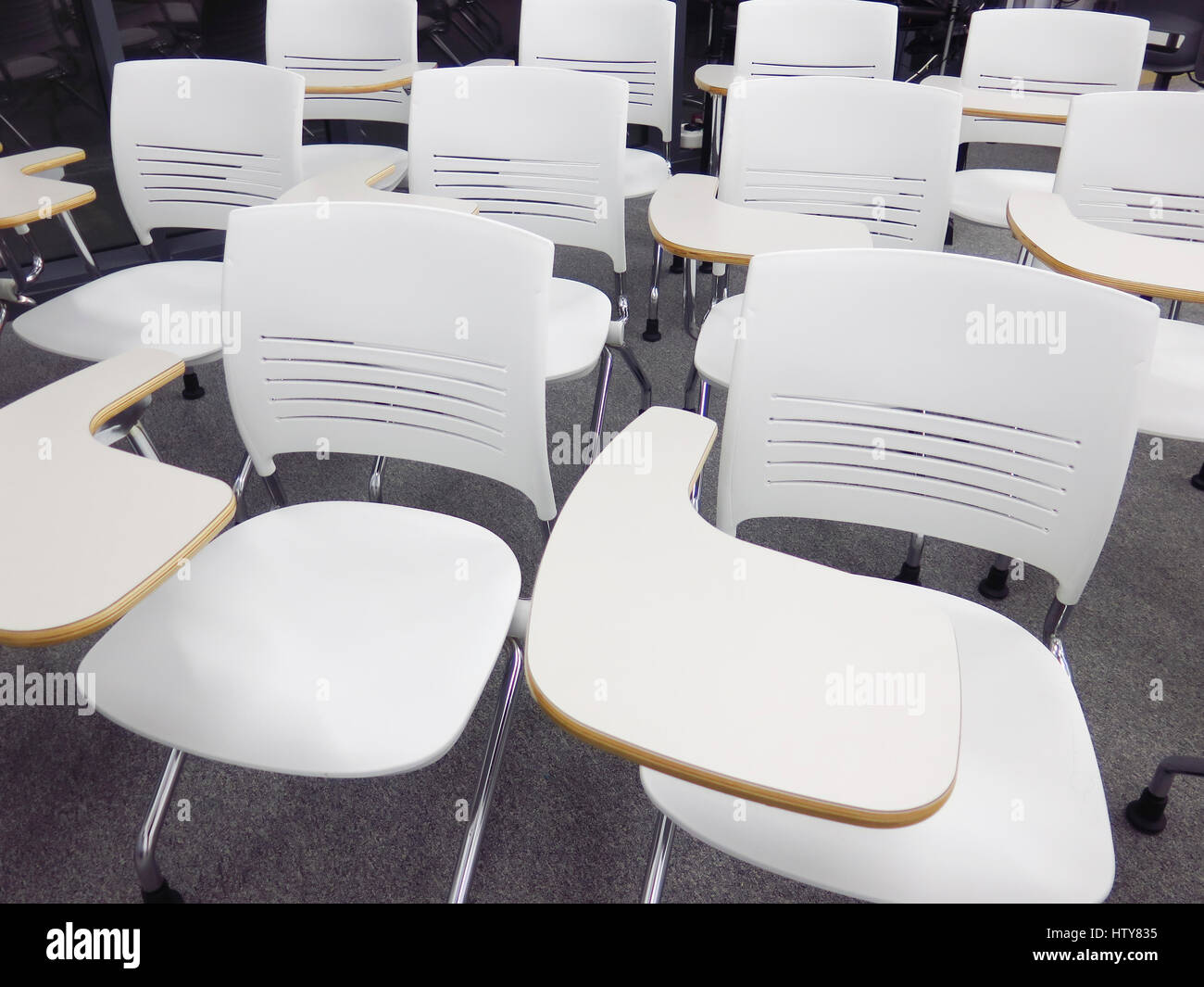 Student chairs arranged in classroom Stock Photo - Alamy