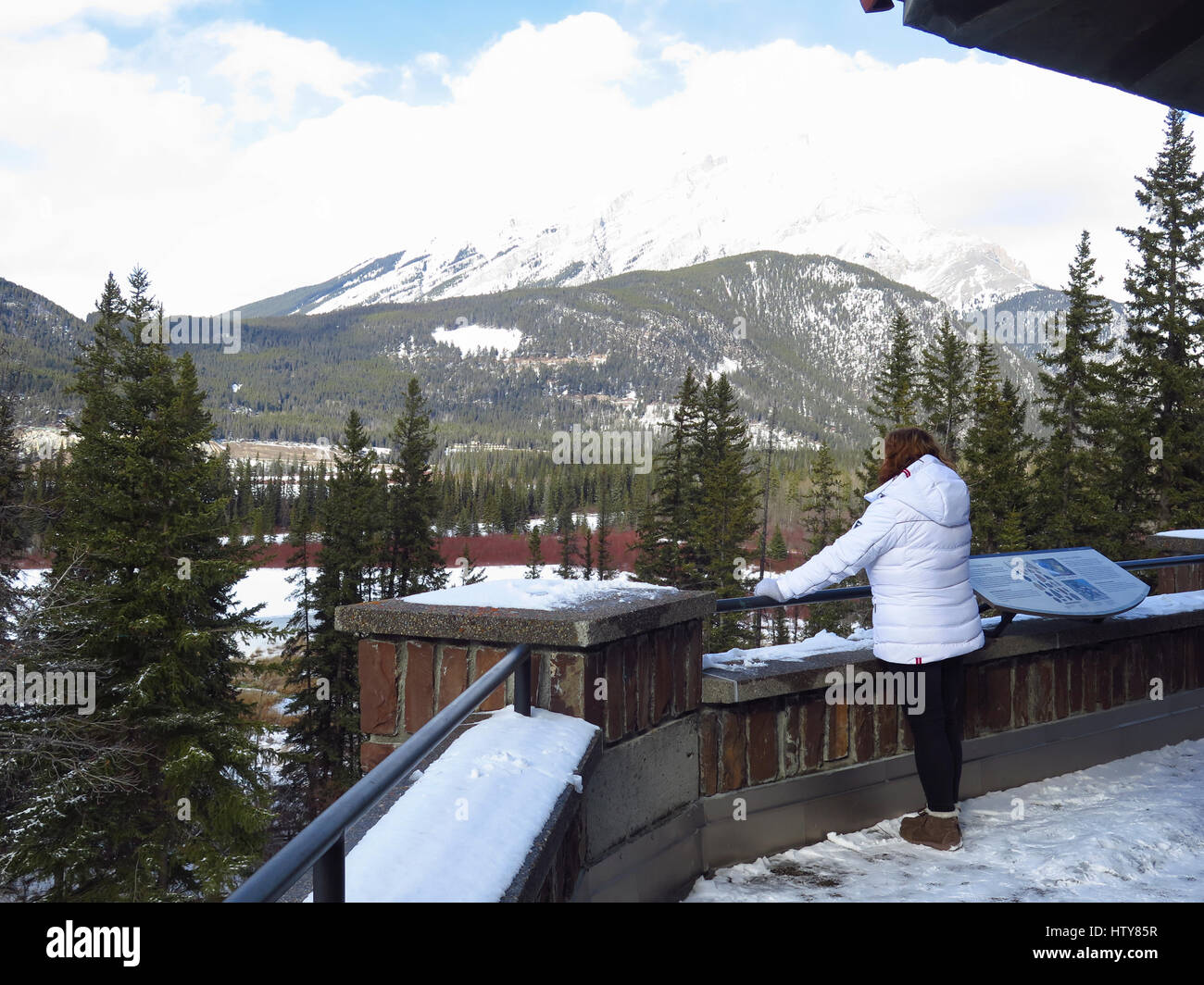 Woman looking over Bow River Valley in Banff in winter Stock Photo