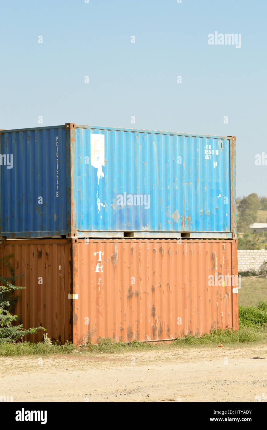 Two metal containers lying along a road in Kenya Stock Photo