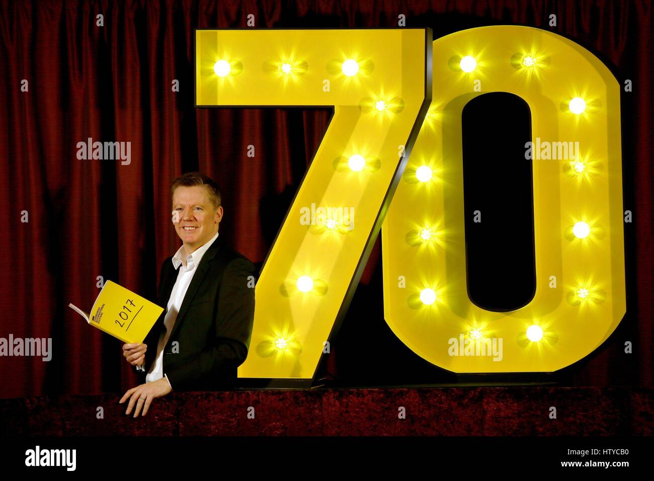 Fergus Linehan, director of the Edinburgh International Festival, poses with props reflecting the 70th anniversary of the festival in August this year. Stock Photo