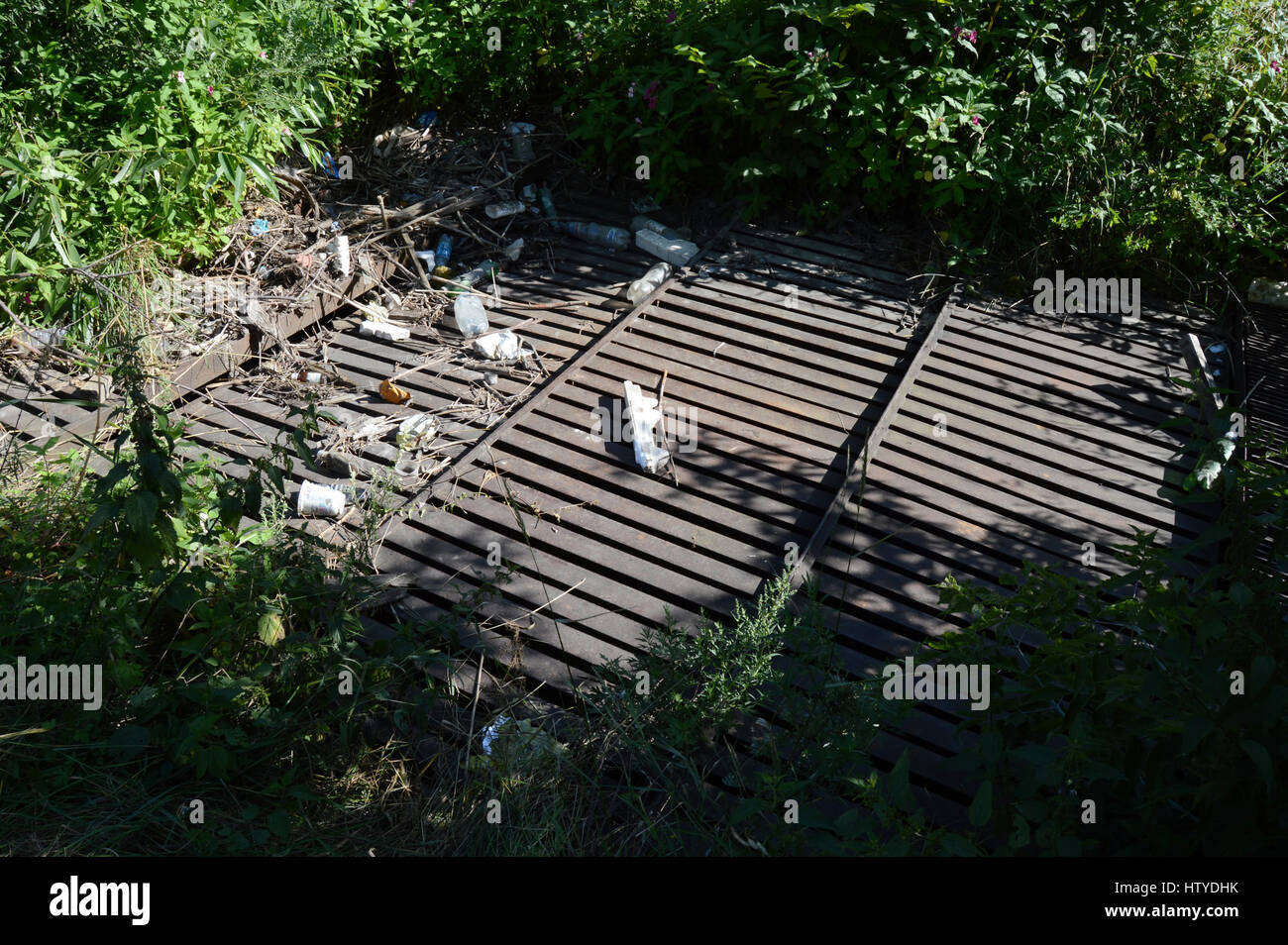 KOVROV, RUSSIA - JULY 25, 2015: Drainage ditch littered with debris Stock Photo