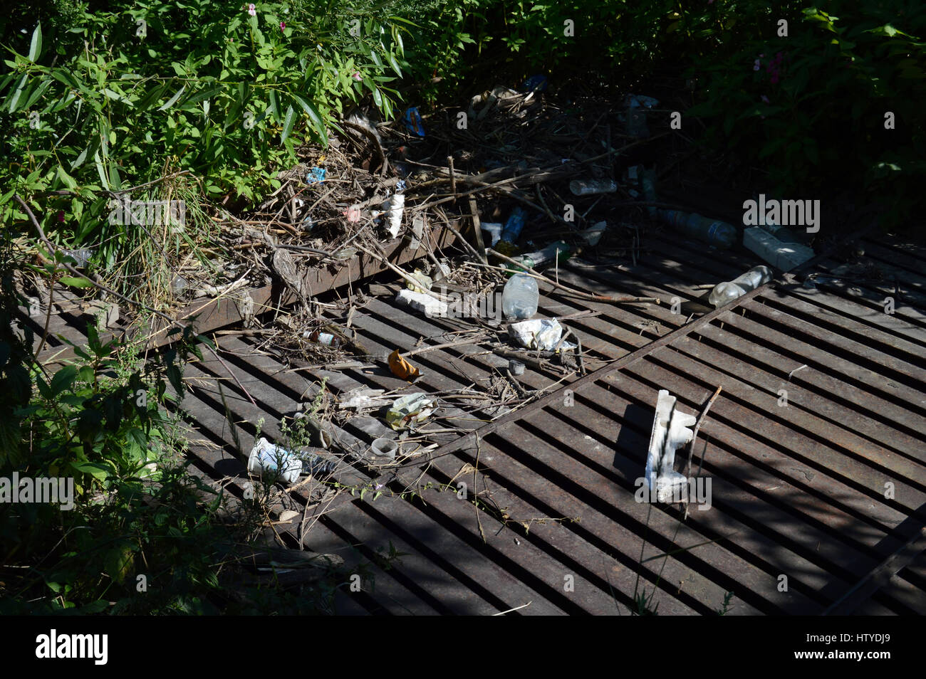 KOVROV, RUSSIA - JULY 25, 2015: Drainage ditch littered with debris Stock Photo