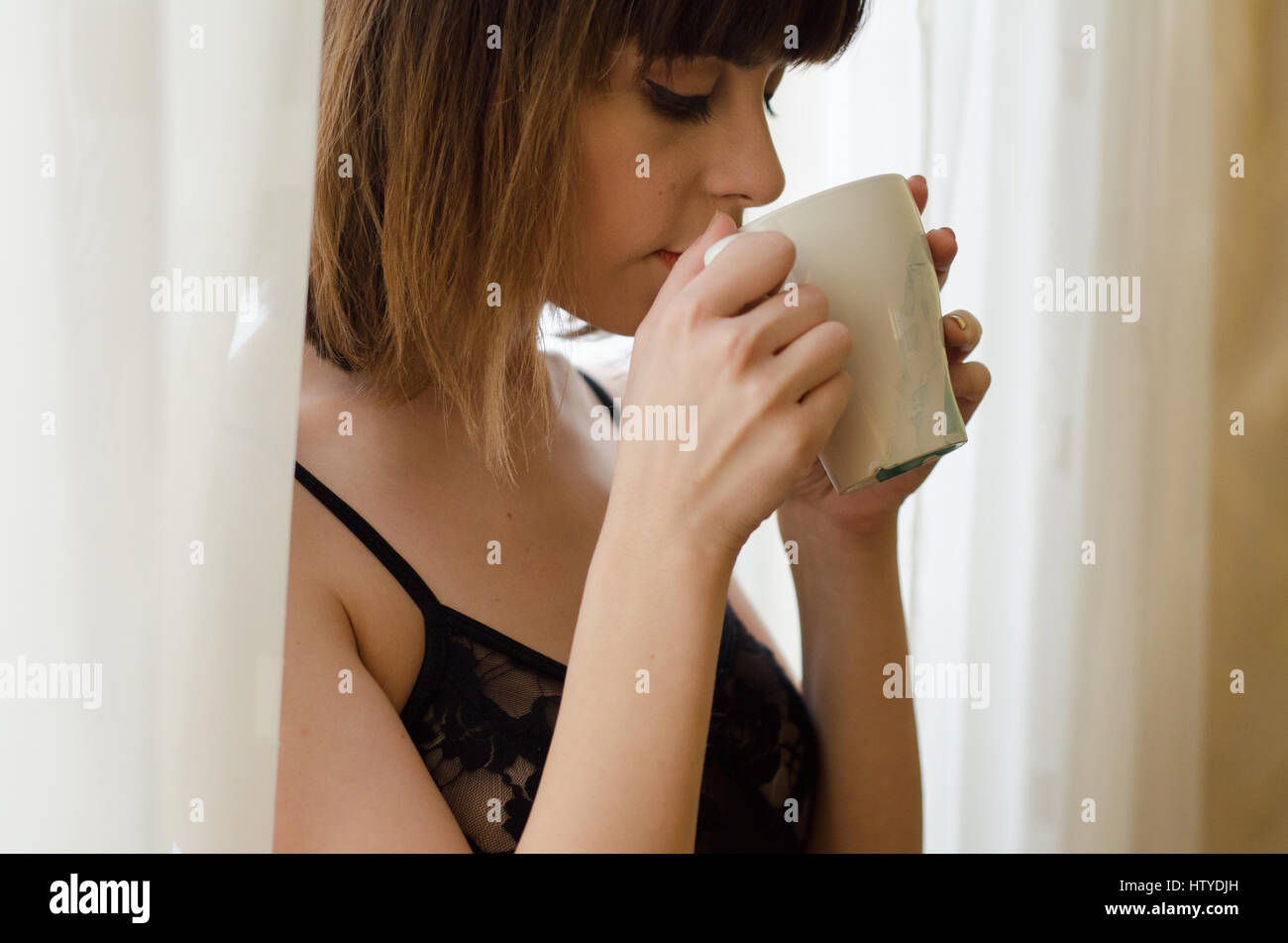Portrait of a woman drinking coffee Stock Photo