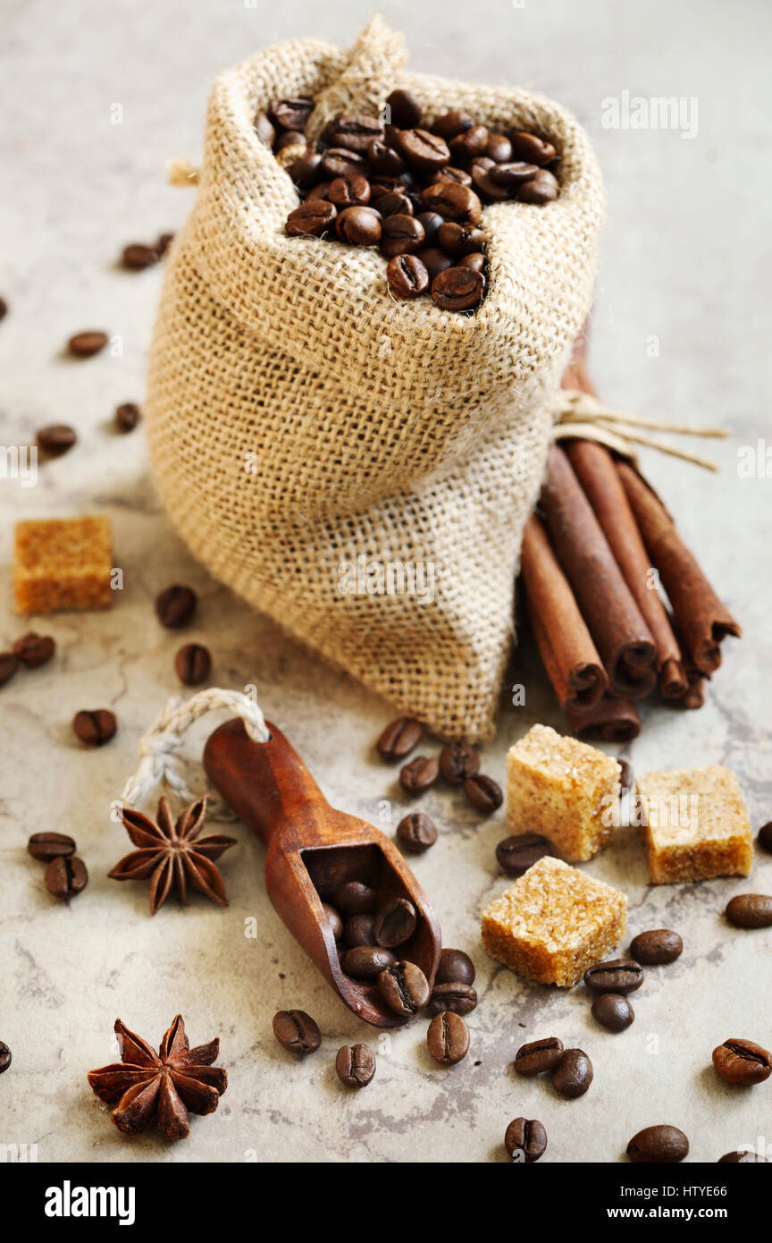 Bag with Roasted coffee beans, brown sugar, cinnamon sticks and star anise Stock Photo