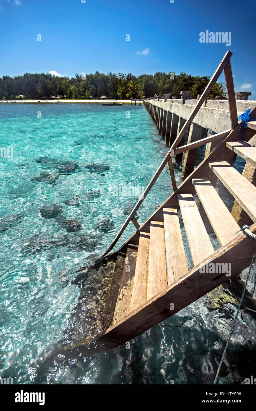 Steps on wooden jetty into ocean, Wakatobi, Sulawesi, Indonesia Stock Photo