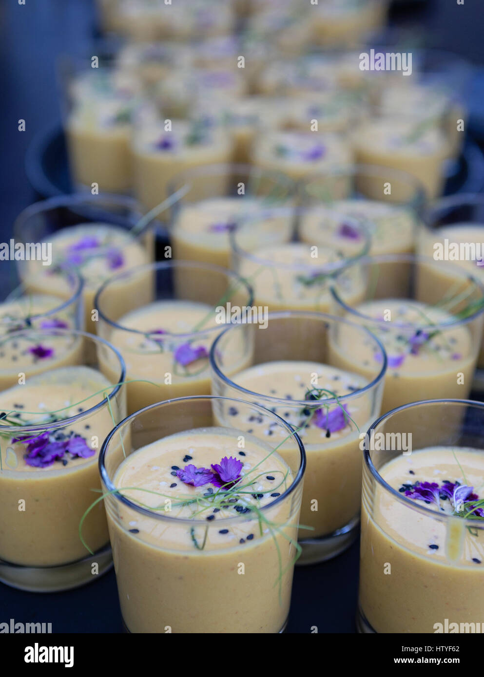 Cold pumpkin soup with edible flowers Stock Photo