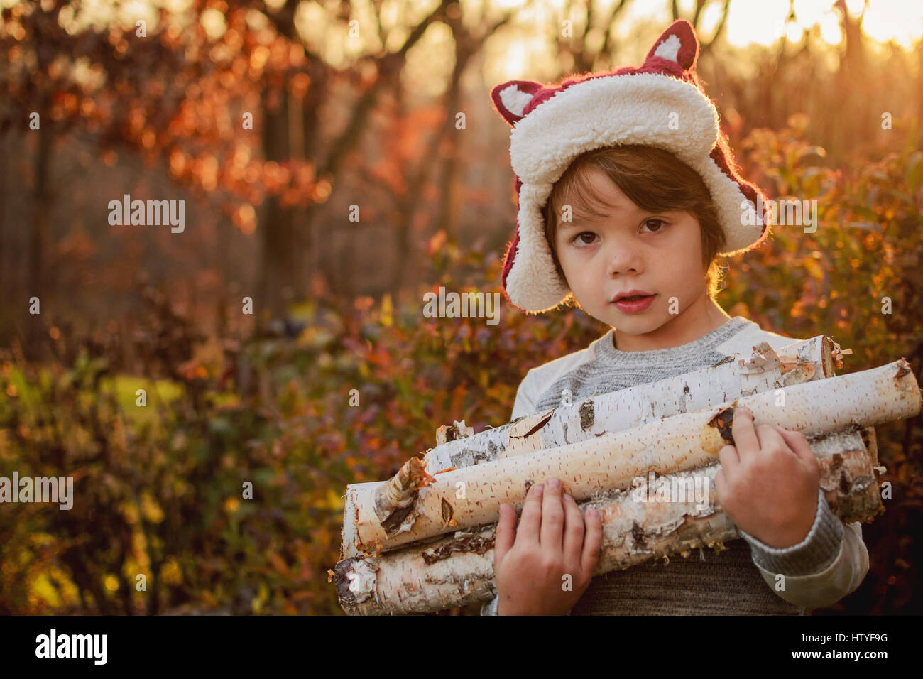 Boy carrying firewood Stock Photo - Alamy