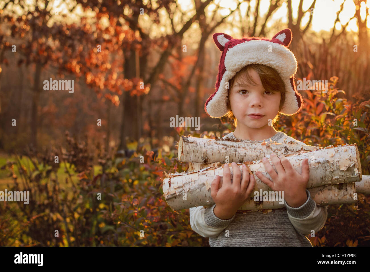 Boy carrying firewood Stock Photo - Alamy