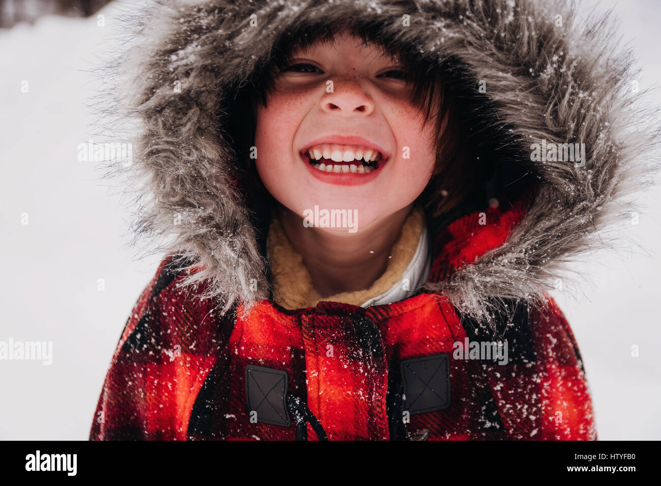 Portrait of a smiling girl in hooded parka Stock Photo