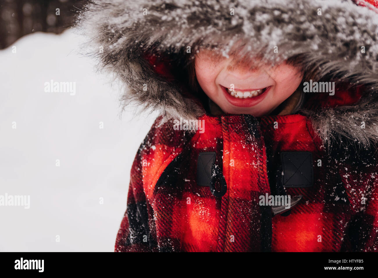 Portrait of a smiling girl in hooded parka Stock Photo